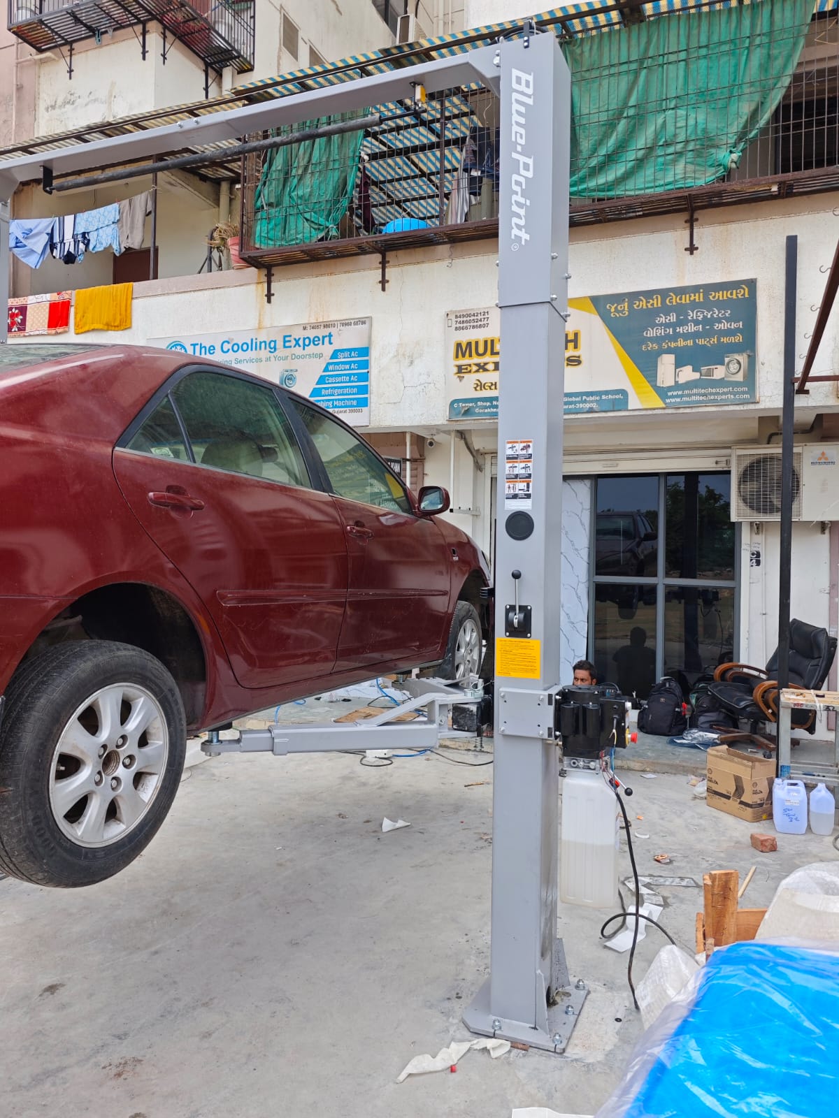 Two-post car lift raising a sedan